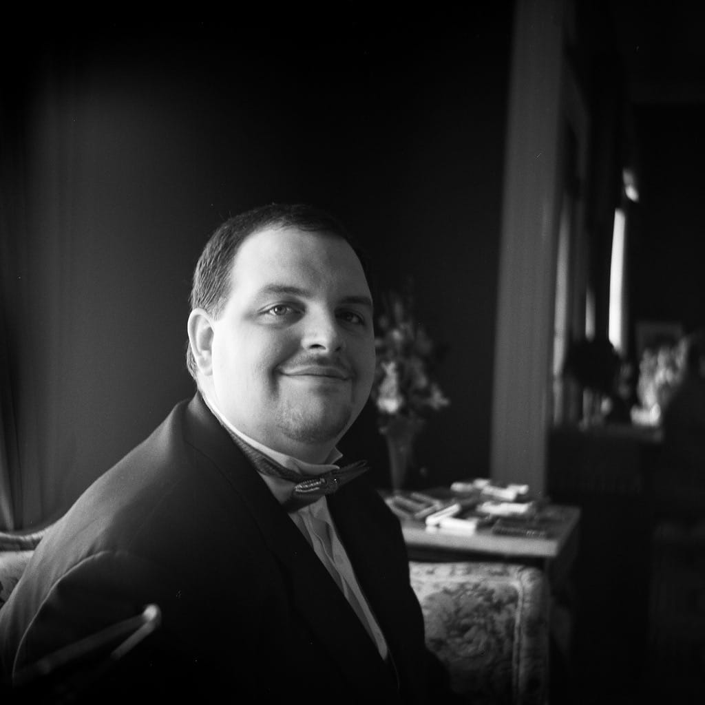 Monochrome photograph of groom before wedding